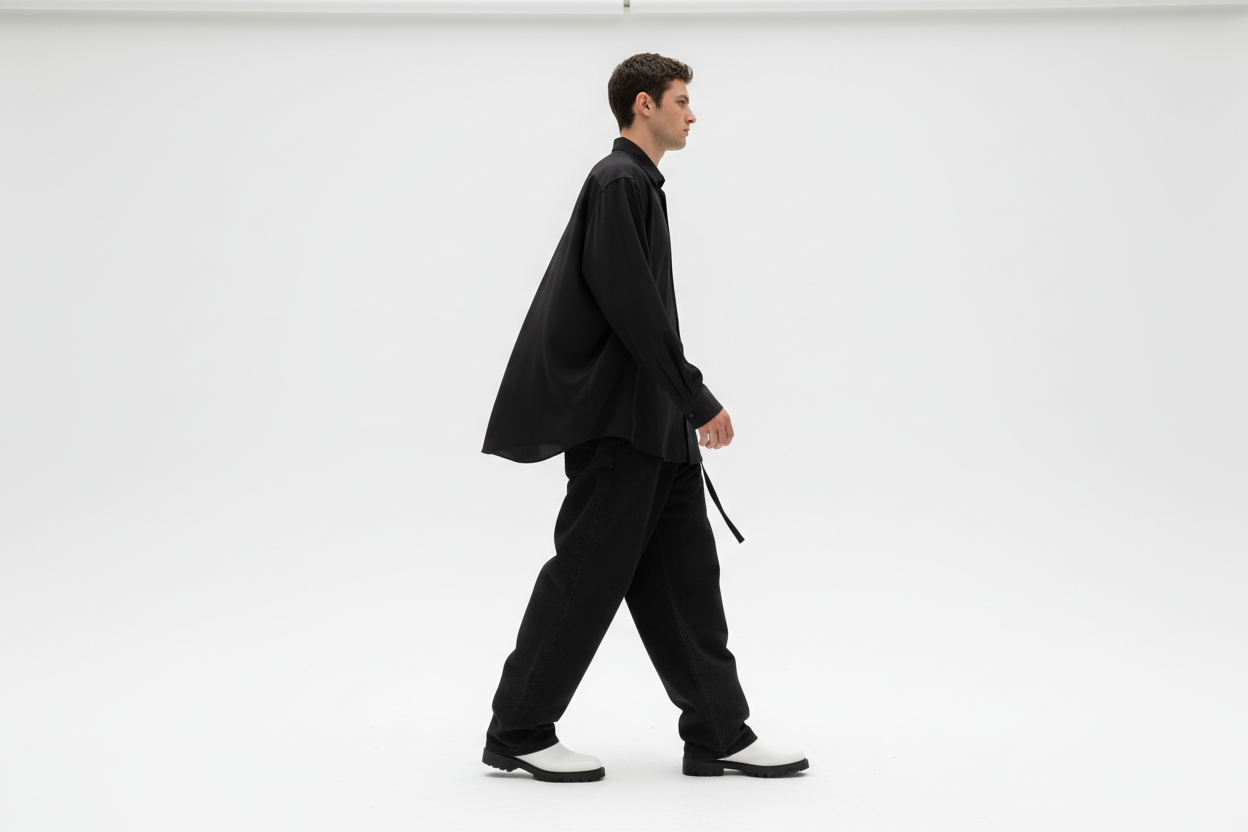 side view a man walking on white back ground place, black full sleeve shirt, black baggy jeans and white boots, a esthetically look